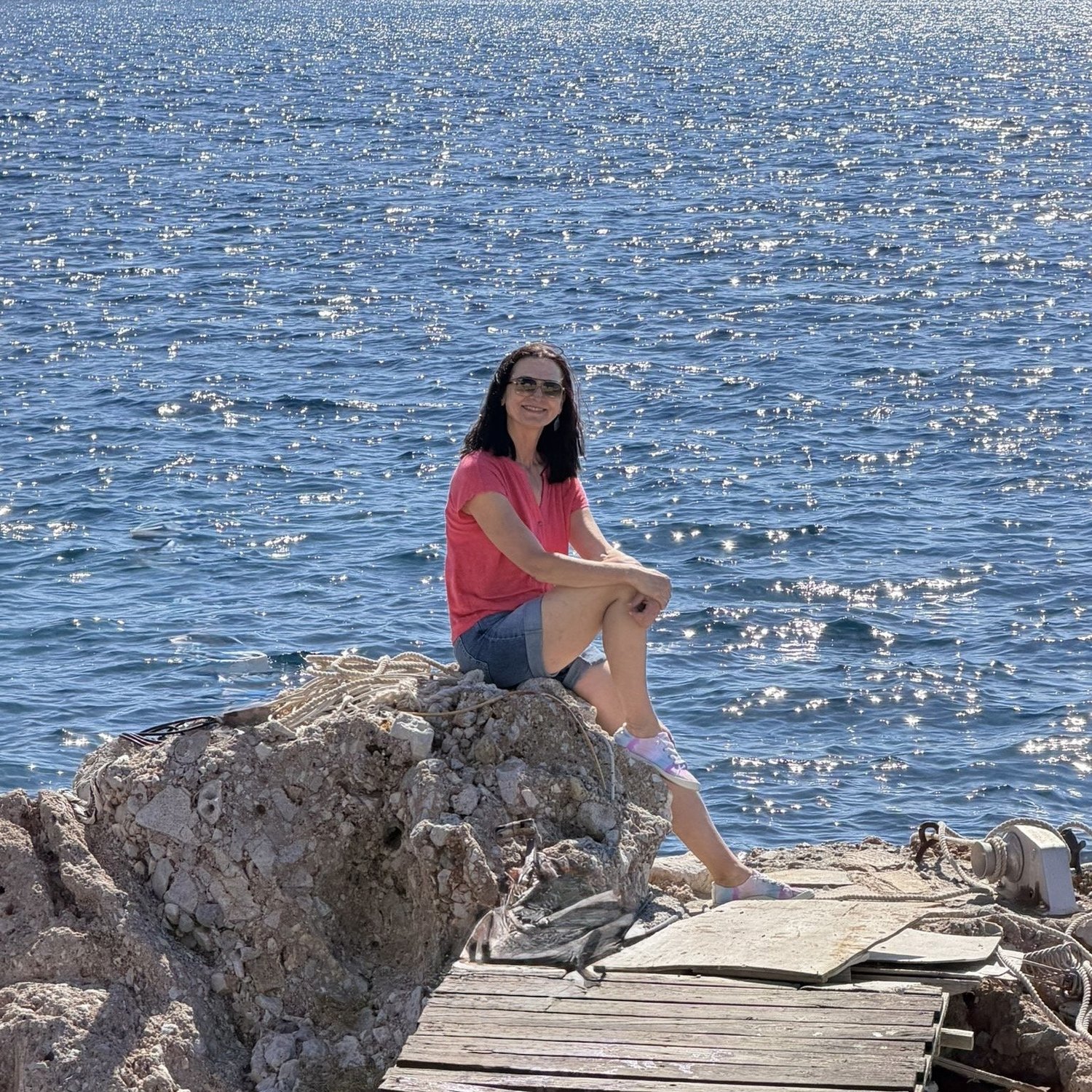 Urszula seated beside the sea on Leros
